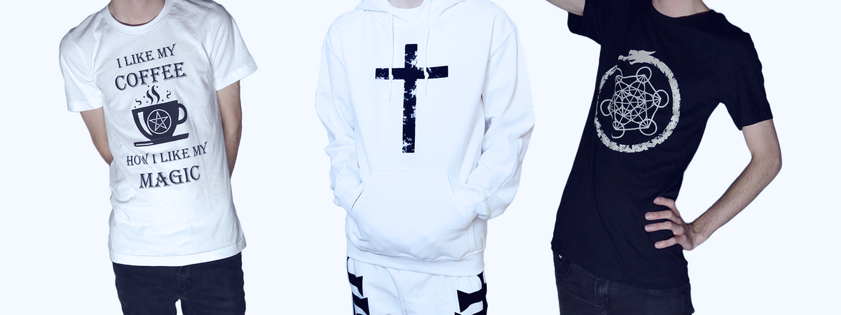 Luvicks Banner featuring three designs. A white shirt with a coffee cup design that says "I like my coffee how i like my magic". A white hoodie with a black cross. A black t-shirt with a ouroboros circling a Metatron’s Cube.